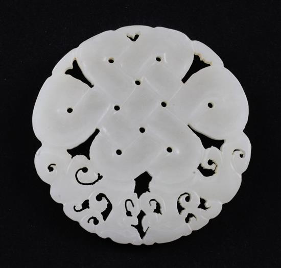 A Chinese celadon-white jade disc, 5.7cm.